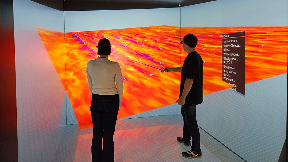 Two scientists view a wind park simulation in the HLRS CAVE.